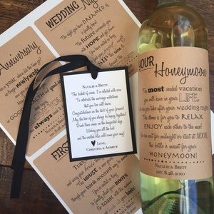 May include: A brown paper wine bottle label with the text "YOUR Honeymoon" and "The most needed vacation you will have in your LIFE" in black text. The label also includes the text "Natalie & Brett Est. 8.28.2010".