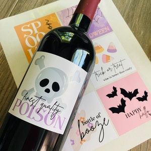 May include: A wine bottle with a Halloween-themed label that reads "finest quality POISON" with a skull and crossbones graphic. The label is white with purple text and a gray skull. The bottle is surrounded by other Halloween-themed labels with text like "trick or treat" and "bottle of booze".
