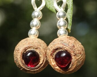 Earrings made of eucalyptus seed pods, garnets and sterling silver spheres
