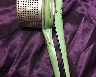 Truly vintage all metal ricer with green handles