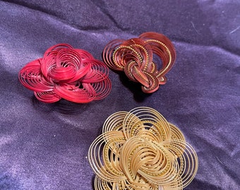 Lot 3 quilled straw or reed brooches