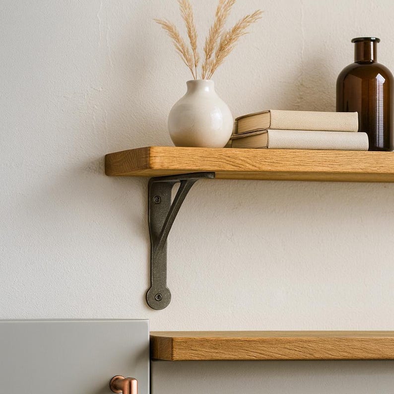 Rustic cast iron wall support holding wooden shelf in farmhouse interior