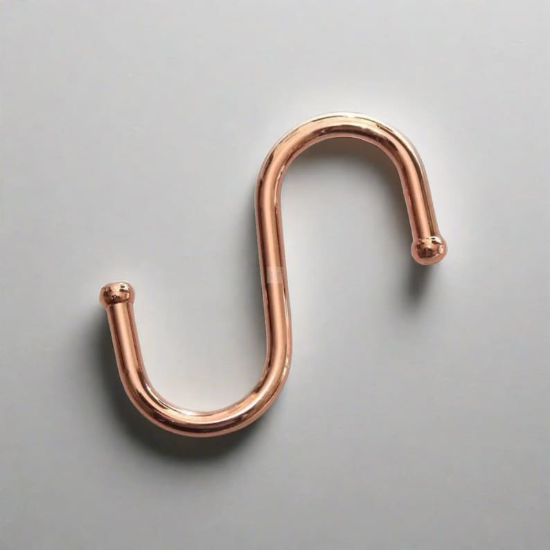 One copper S-hook which serves as a useful hook for hanging various items.