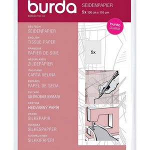May include: A package of Burda tissue paper, 5 sheets, each measuring 150 cm x 110 cm. The packaging is pink and white, with text in multiple languages, including English "TISSUE PAPER". Illustrations show sewing and pattern making.