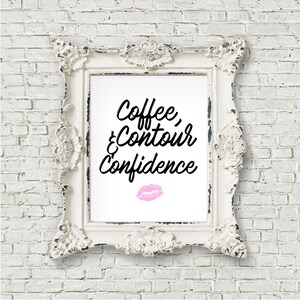 May include: White framed print with black text that reads "Coffee, & Contour Confidence" with a pink lipstick kiss mark below the text.