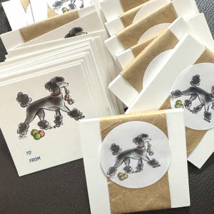 May include: A collection of white cards and gift tags featuring a black poodle illustration. The poodle is depicted with a red collar and holding colorful beads. Some cards have "TO" and "FROM" text.