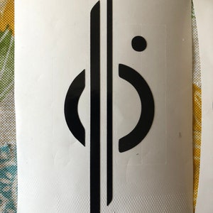 May include: Black and white graphic design with two vertical lines and a circle with a dot in the center.