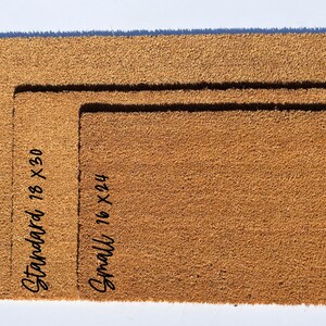 May include: Three doormats in different sizes: large, standard, and small. The doormats are made of brown coir and have the size measurements written on them in black.