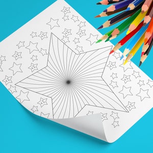 May include: A white coloring page featuring a large starburst design and smaller star shapes. A collection of colored pencils in various colors are arranged at the top right corner of the page. The page is on a blue surface.