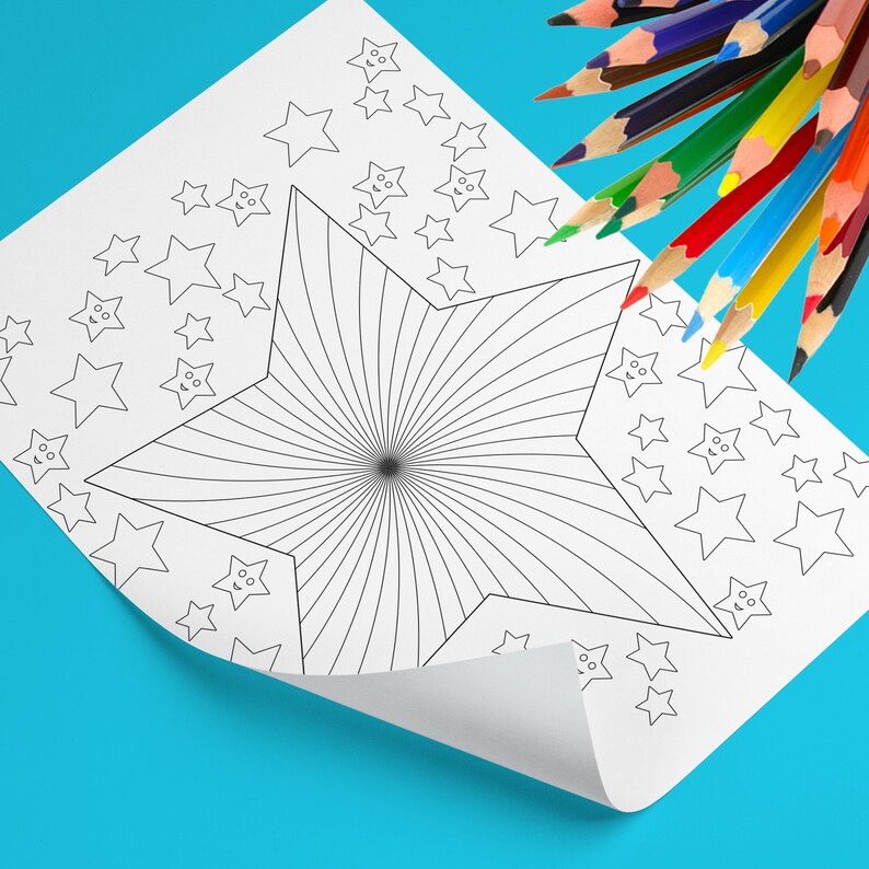 May include: A white coloring page featuring a large starburst design and smaller star shapes. A collection of colored pencils in various colors are arranged at the top right corner of the page. The page is on a blue surface.