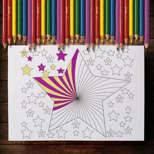 May include: A coloring page with a large star design, partially colored with yellow and purple stripes, surrounded by smaller star outlines. A row of colored pencils in various colors sits above the page.