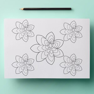 May include: A white sheet of paper with five black floral designs, each with multiple layers of petals. A black pencil rests at the top. The designs are for coloring or drawing.