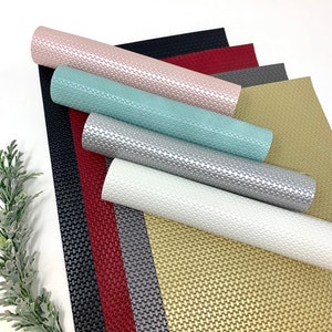 May include: A set of eight faux leather sheets in various colors, including gold, silver, white, red, gray, black, pink, and teal. The sheets have a textured, woven pattern.