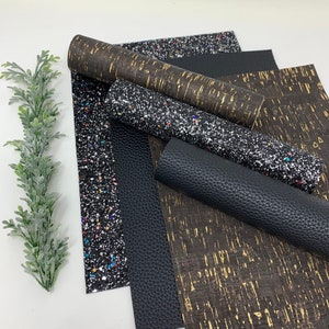 May include: A set of five fabric sheets in black and gold colors. The sheets have different textures, including glitter, cork, and faux leather.