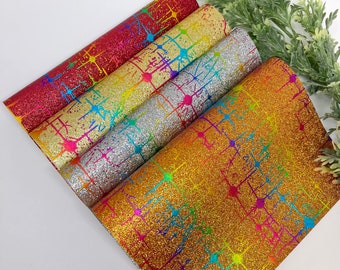 May include: A set of five sheets of glitter fabric with a rainbow splatter design on a grid pattern. The sheets are in red, gold, silver, light gold, and dark gold.