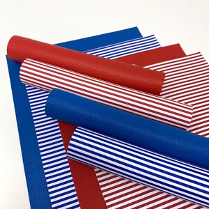 May include: A set of red and blue striped faux leather sheets. The sheets are rolled up and arranged in a stack.