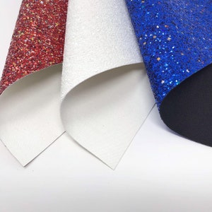 May include: Three sheets of glitter fabric in red, white, and blue. The fabric is folded in a triangular shape.