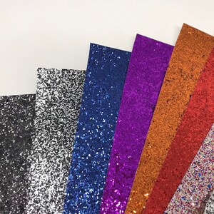 May include: Assortment of glitter paper sheets in various colors, including black, silver, blue, purple, orange, and multi-colored.