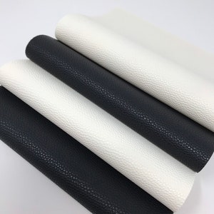 May include: Four pieces of faux leather in black and white. The leather has a textured surface.