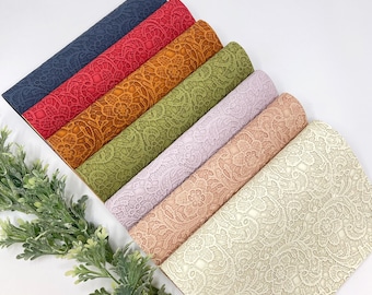 May include: A set of seven faux leather sheets with a lace pattern. The sheets are in various colors, including navy blue, red, orange, green, lavender, peach, and cream.
