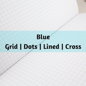 May include: Open notebook with white grid paper. A light blue banner across the center displays the word "Blue" above the words "Grid | Dots | Lined | Cross". The notebook is open, showing the grid pattern.