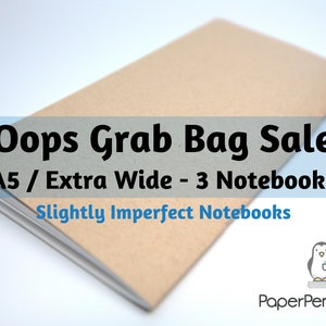 May include: A stack of three A5 size notebooks with a light brown cover. The text "Oops Grab Bag Sale" is displayed above the notebook, with "A5 / Extra Wide - 3 Notebooks" and "Slightly Imperfect Notebooks" below. A penguin logo is in the bottom right.