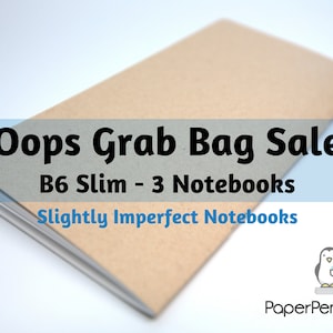 May include: A stack of three B6 slim notebooks with slightly imperfect pages. The notebooks are tan with gray spines. The image includes the text "Oops Grab Bag Sale" and "PaperPenguinCo" logo.