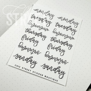May include: A sheet of white stickers with the days of the week in black cursive font. The stickers are arranged in two columns, with each day of the week repeated. The text "CHIC STREET STICKER BOUTIQUE" is printed at the bottom.
