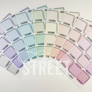 May include: A set of 10 sheets of pastel colored square stickers with a black border and glitter accents. Each sheet has 9 stickers.