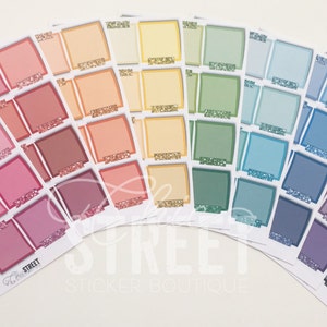 May include: A set of colorful square stickers with a rainbow gradient. The stickers are blank and can be used for journaling, planning, or scrapbooking.