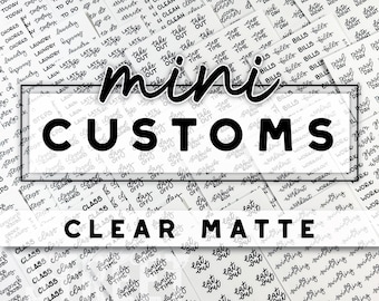 May include: A close-up of a variety of clear matte mini custom stickers with black lettering. The stickers feature a variety of phrases, including "Class", "Family Time", "Eat Out", "Day Off", "To Do", "Laundry", "Late", "Take Out", "Time", "Bills", "Workout", and "Swimming".