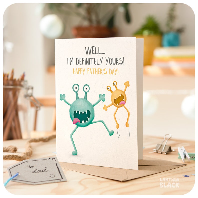 May include: A greeting card with a green and yellow monster illustration. The card reads "WELL... I'M DEFINITELY YOURS! HAPPY FATHER'S DAY!"
