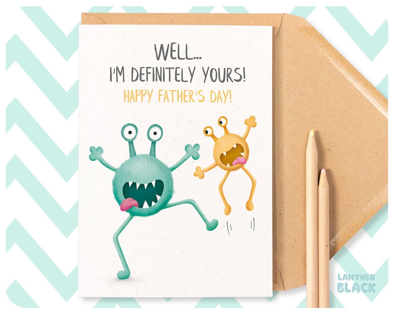 May include: A greeting card with a light blue and yellow monster illustration. The card reads "Well... I'm definitely yours! Happy Father's Day!"