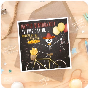 May include: A humorous birthday card featuring a stick figure wearing a sombrero and riding a bicycle. The stick figure is holding a pizza with candles and balloons. The card has the text "Happio Birthday10! As they say in... Nowhere at all."