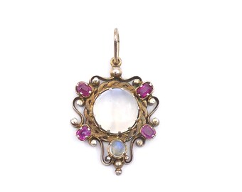 Edwardian moonstone and ruby pendant, exceptionally beautiful antique pendant set with a moonstone cabochon and rubies on a 9kt gold chain.