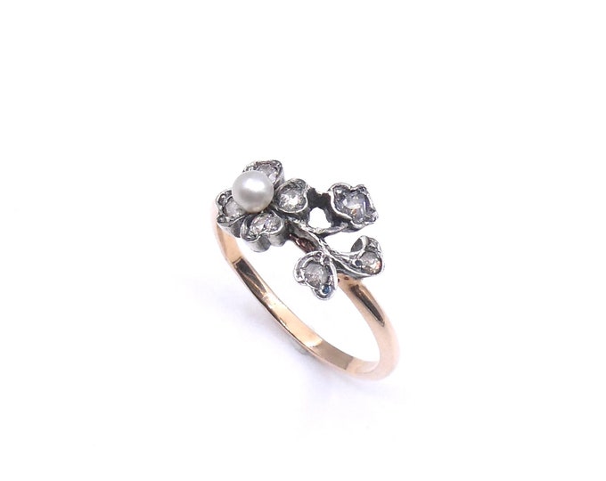 Diamond pearl ring, edwardian in style set with a central pearl and diamonds  floral and leaf motif
