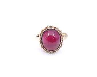 Antique style ruby ring, with a lab grown  cabochon ruby with a rope border and raised setting.
