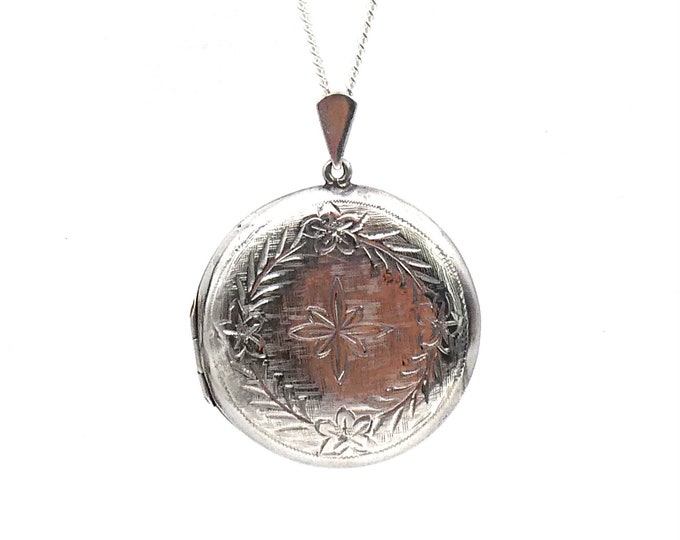 Vintage silver locket, engraved decorative locket in silver on a fine chain, with a floral motif.