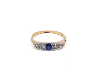 Antique five stone ring, a  sapphire diamond ring in an elegant setting with a vibrant blue oval sapphire. .