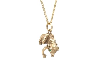 Vintage frog charm, a gold frog with green enamel eyes and articulated arms that move up and down.