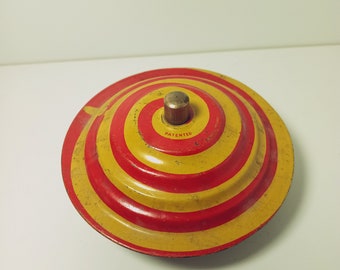 Vintage Tin Lithograph Spinning Top Flying Saucer Red Yellow Swirl Ringing Noise Toy