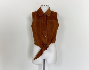 May include: A brown suede vest with a button-up front and a tie at the waist.