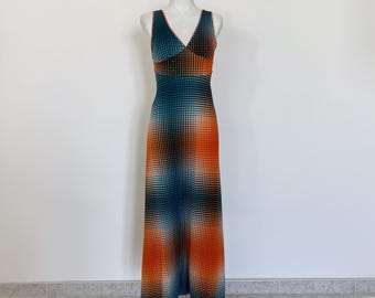 May include: A sleeveless maxi dress with a V-neckline and a geometric pattern in shades of orange, green, and white.