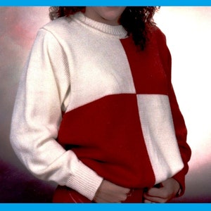 May include: A white and red knit sweater with a checkered pattern. The sweater has a crew neck and long sleeves.