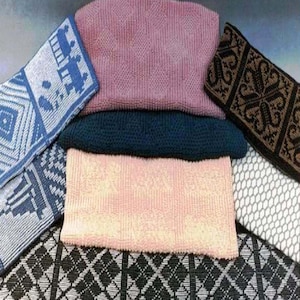 May include: A stack of knitted fabric swatches in various colors and patterns, including blue, pink, black, and white. The swatches are arranged in a layered fashion, showcasing different knitting techniques and designs.