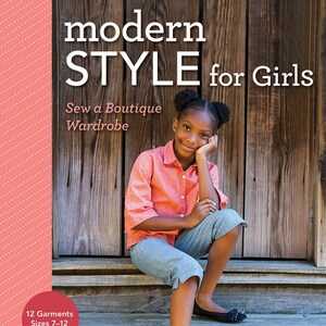 May include: A book cover with the title "modern STYLE for Girls" and the subtitle "Sew a Boutique Wardrobe". The cover features a young girl sitting on wooden steps, wearing a pink shirt and blue jeans. The book is for sewing 12 garments in sizes 7-12.