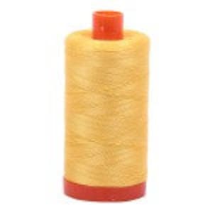 May include: A spool of gold thread with an orange plastic bobbin.