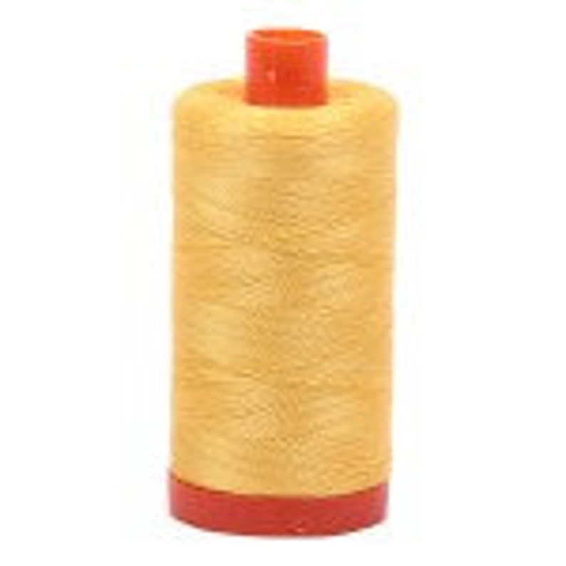 May include: A spool of gold thread with an orange plastic bobbin.