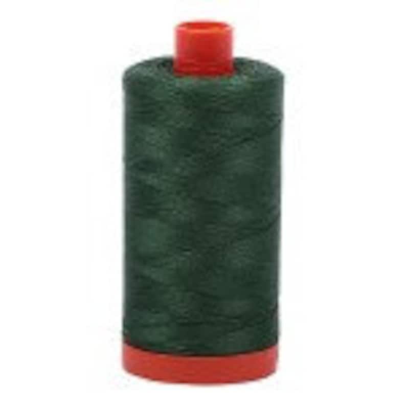 May include: A spool of dark green thread with a red plastic bobbin.