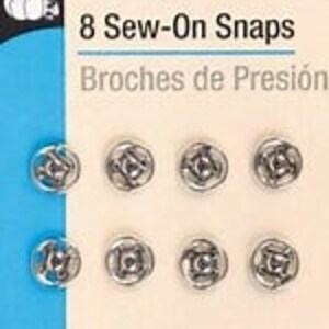 May include: A pack of 8 nickel-plated brass sew-on snaps. The package says "Dritz 8 Sew-On Snaps" and "Broches de Presión".